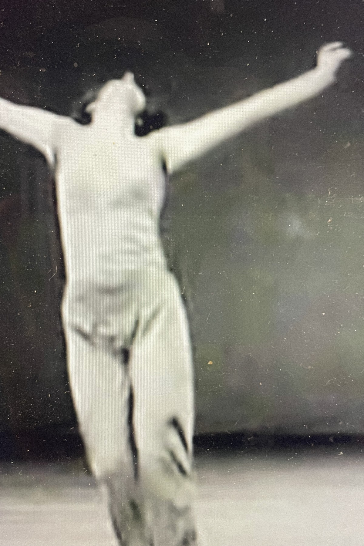 Trisha Brown figure with arms outstretched